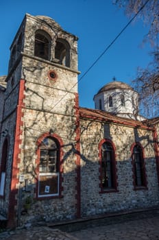 Old stonemason St. Panteleimon church with belfry. Palaios Panteleimonas, Pieria, Greece.