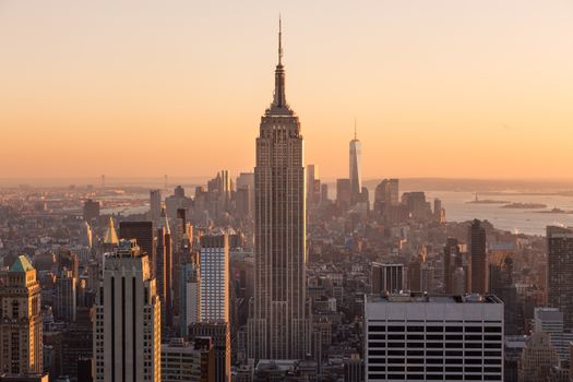 Golden sunset panoramic view of building and skyscrapers in Midtown and downtown skyline of lower Manhattan, New York City, USA.