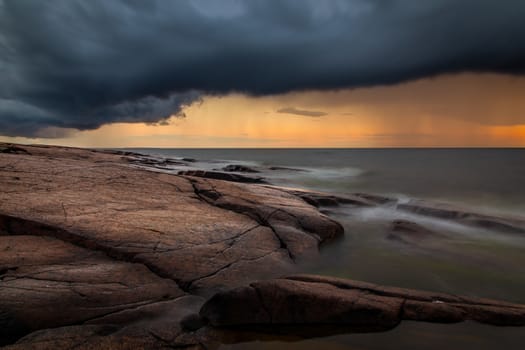 A sunset image with very dark rain clouds. The picture is taken in Pori, Finland.