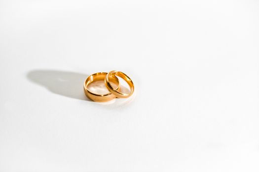 Two golden rings on a white background.