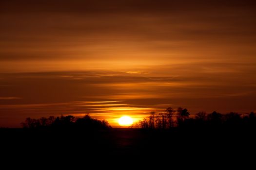 The sun goes down to the woods in Luvia, Finland