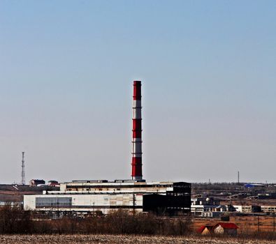 Thermal power plant in the industrial zone in early spring. Russia, city Saratov.