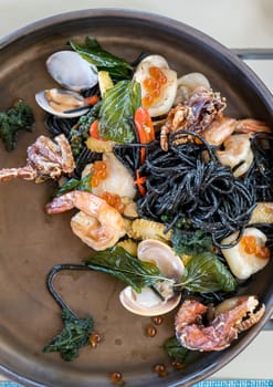 The Mediterranean delicacy food. Black seafood pasta spaghetti  with mussels calm shrimp and crab