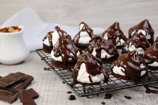 Delicate chocolate chip cookies with airy Italian meringue under chocolate glaze on the rack