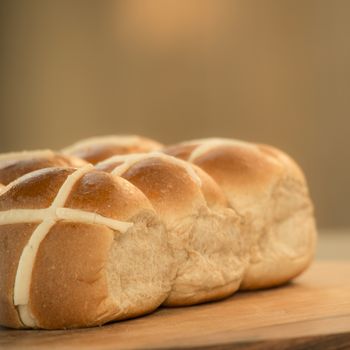 Tasty traditional Easter hot cross buns, closeup view.