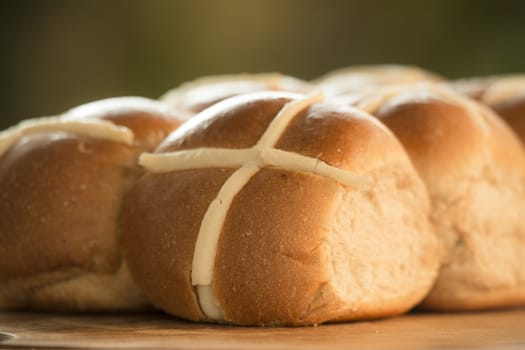 Tasty traditional Easter hot cross buns, closeup view.
