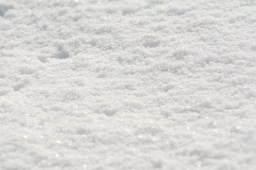 Fluffy fresh white snow sparkling in sunlight, as an abstract winter background