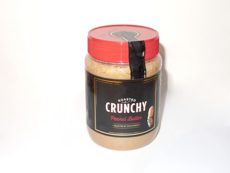 crunchy peanut butter red bottle jar white background food; essex; england; uk