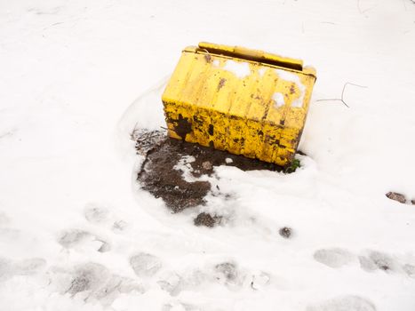 fallen turned over yellow grit box salt outside snow storm; essex; england; uk