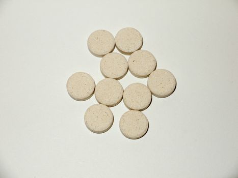 white pale circle tablets pills group of white background studio; essex; england; uk