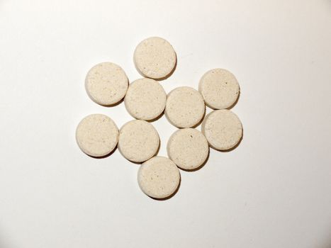 white pale circle tablets pills group of white background studio; essex; england; uk