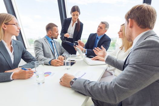 Business team meeting. People in office working with laptop computer and financial reports in desk