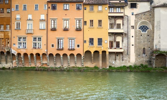 Ancient houses overlooking the Arno river in Florence, Italy