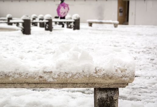 close-up view of an old decorated snow-covered marble bench in Piazza Navona in Rome, Italy