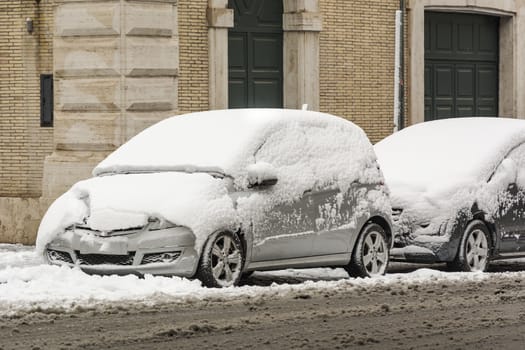 parked cars covered with snow. Winter and cold temperatures concept