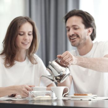 Couple having breakfast together at home 