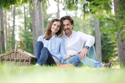 Young beautiful couple on picnic in summer park