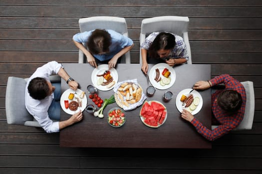Four friends having dinner, top view