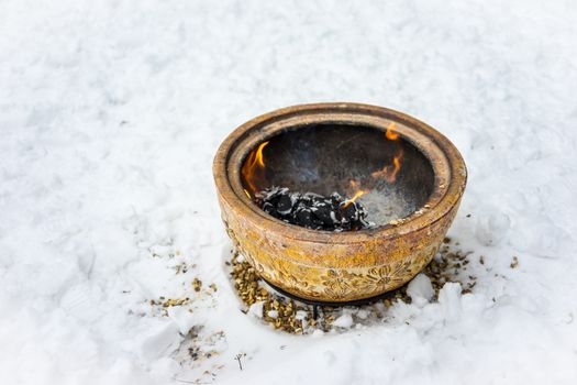 Fire bowl heating in a cold snowy winter.