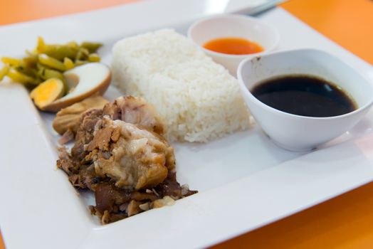 Thai famous stewed pork leg rice with boiled egg and vegetable