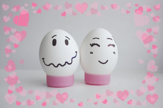 Cheerful eggs with two face on white background on stand concept of embarrassed shyness.Photo for your design Frame of hearts. love