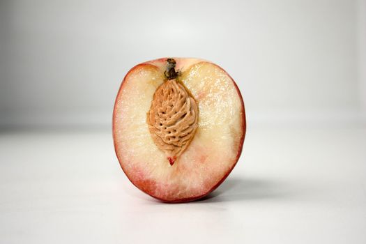 Peach with a bone of the lobule. Photo for your design.
