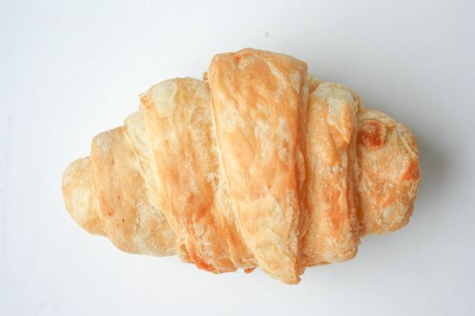 Croissant on a white background light. Photo for your design.
