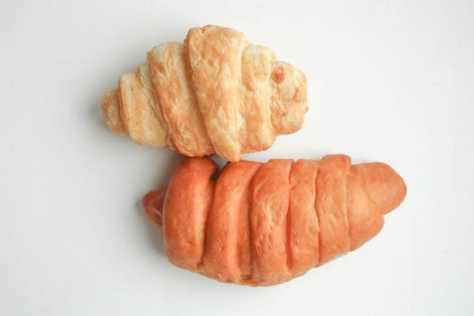 Croissant two on a white background light and dark. Photo for your design.
