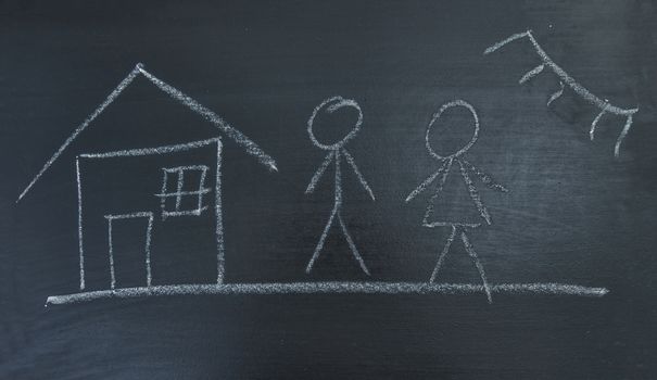 Family, house and sun, painted chalk on a black board