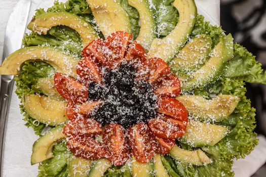 salad with avocado and tomato on a festive table.