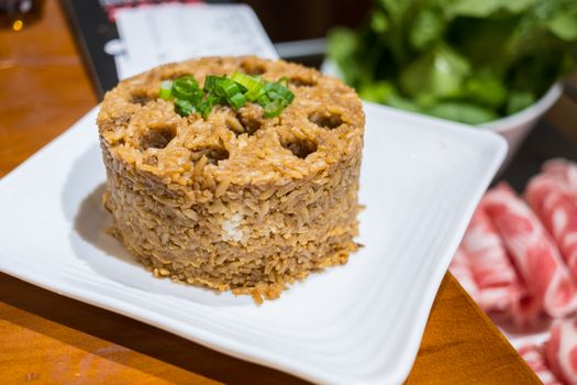 A plate of chinese fried rice in a chinese restaurant