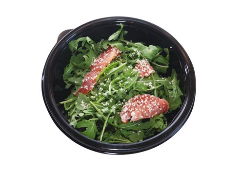 Black plastic bowl with salmon and greens isolated on white background