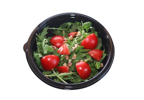 Black plastic bowl with tomatoes and greens isolated on white background