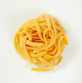 bundle of dried ribbon pasta on white background