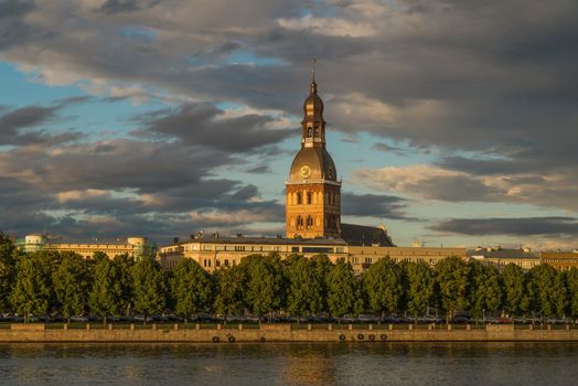 View of the Riga House Cathedral from the river side in a summer evening