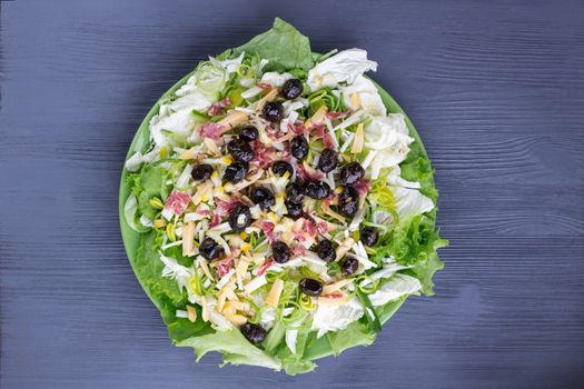 Green salad with vegetables, olives, cabbage, onions, sausages for healthy fitness slim diet