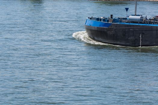 Bug of a large merchant ship, container ship on a large river.