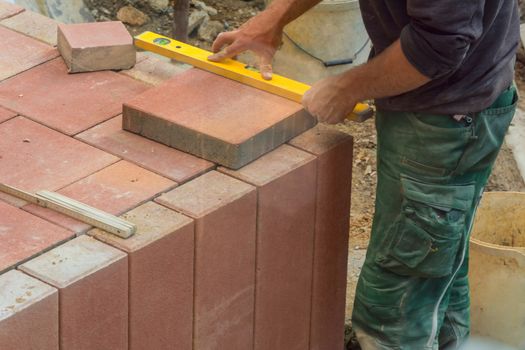 Man cutting stone slabs, concrete slab with an electric grinder