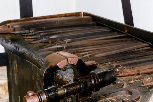 Old workbench with various tools and machines.