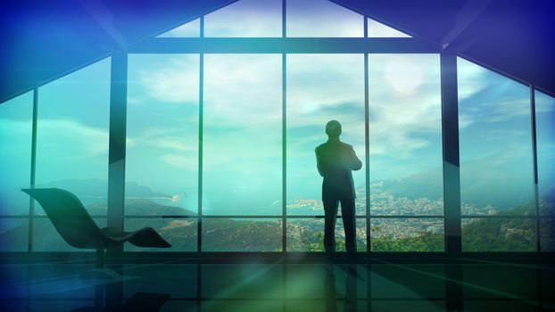 Silhouette of a man in a huge office in front of large windows.