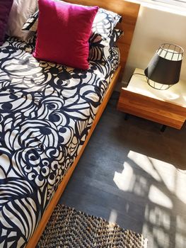 Bright bedroom in sunlight. Contemporary interior design.