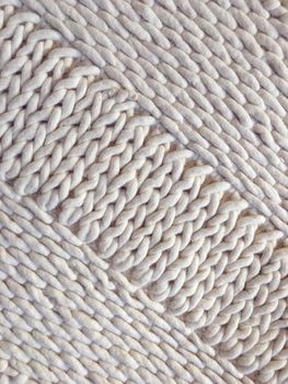 White wool handmade knitted background with simple design.
