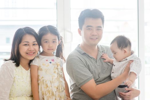 Parents and children. Happy Asian family spending quality time at home, natural living lifestyle indoors.