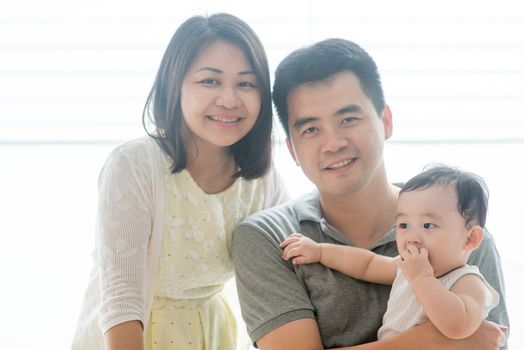 Parents and baby son. Happy Asian family spending quality time at home, natural living lifestyle indoors.