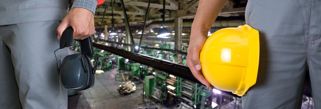 Workers with safety uniform at industrial factory