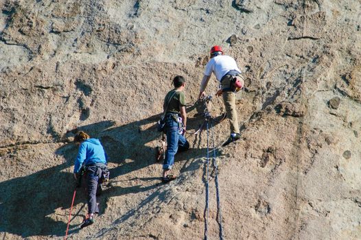 Rock Climbers scale rocks at Lake Perris, CA