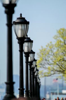 Light posts lined up like soldiers at Battery Park, New York