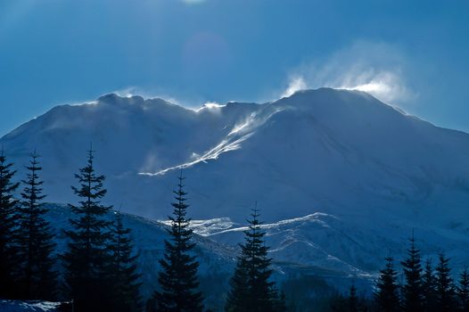 Snow blowing off the peak of mountain near Whistler, British Columbia, Canada