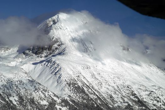 Aerial scene taken from plane flying over mountans of Whistler. BC