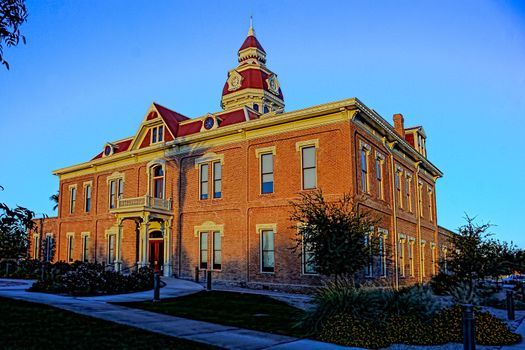 Sun setting on City hall in late fall under clear, blue sky